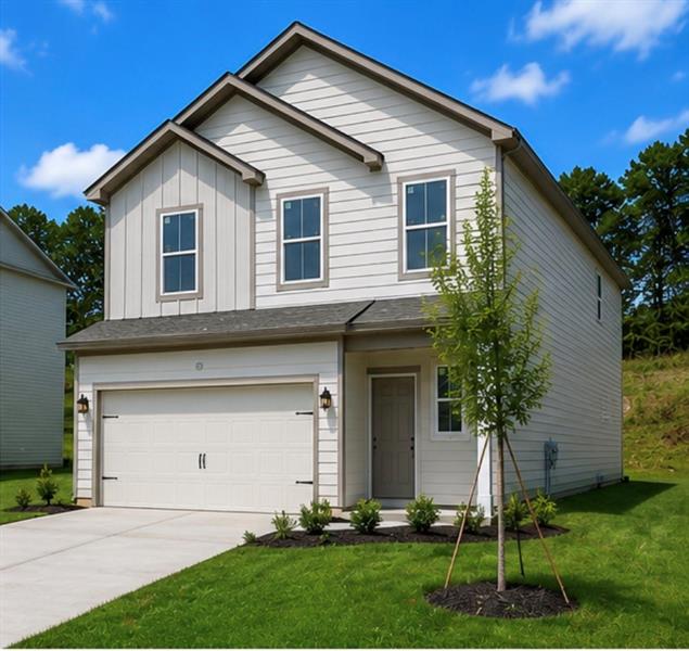 Two-story residence featuring light-colored siding, a two-car garage, and a concrete driveway