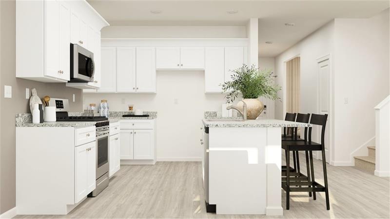 Kitchen featuring appliances with stainless steel finishes, white cabinets, light stone counters, a kitchen bar, and light wood-type flooring